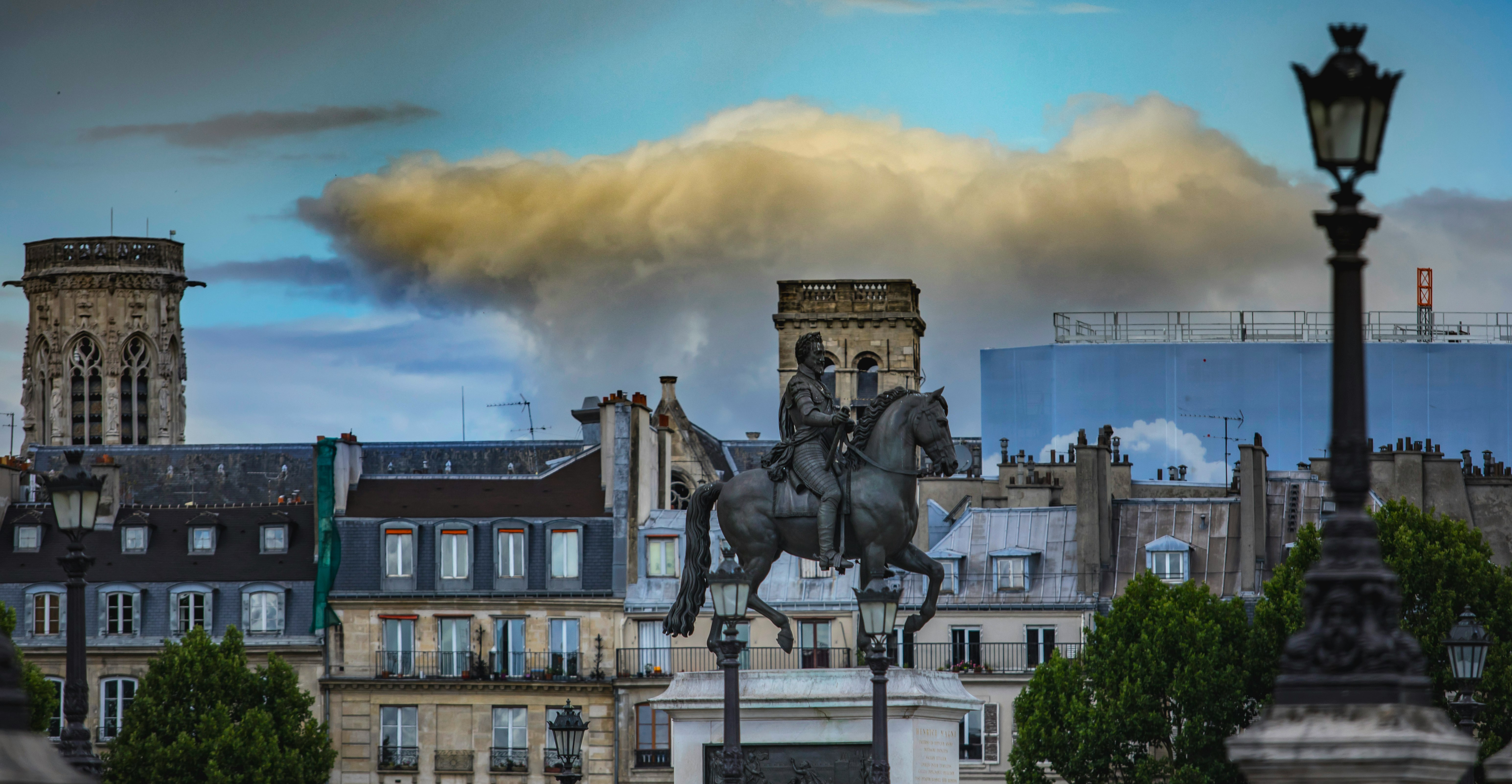 man riding horse statue near building during daytime